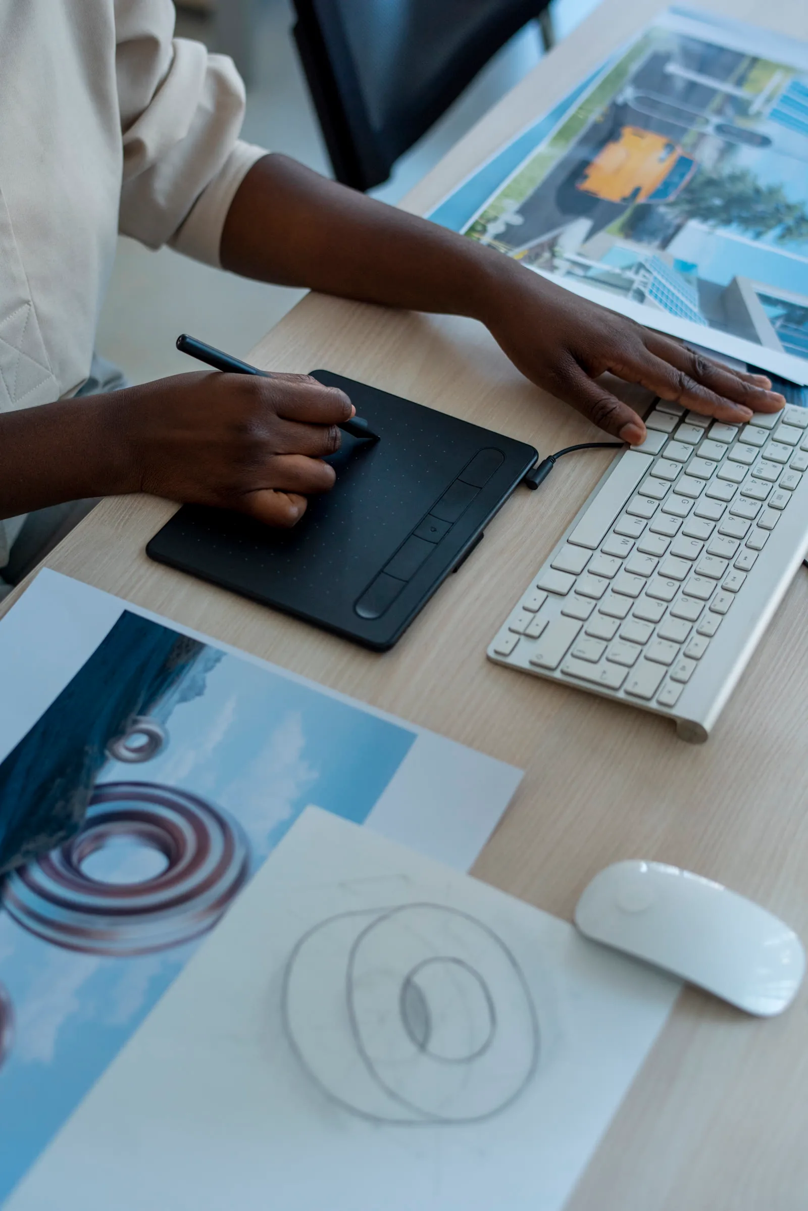 Designer sketching on a tablet at a desk